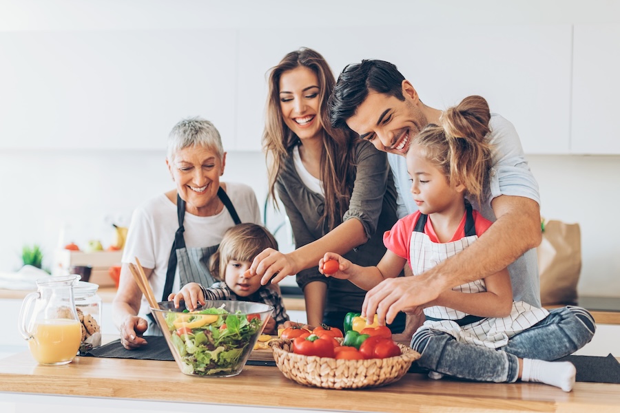 family preparing a healthy meal to help with nutrition and oral health