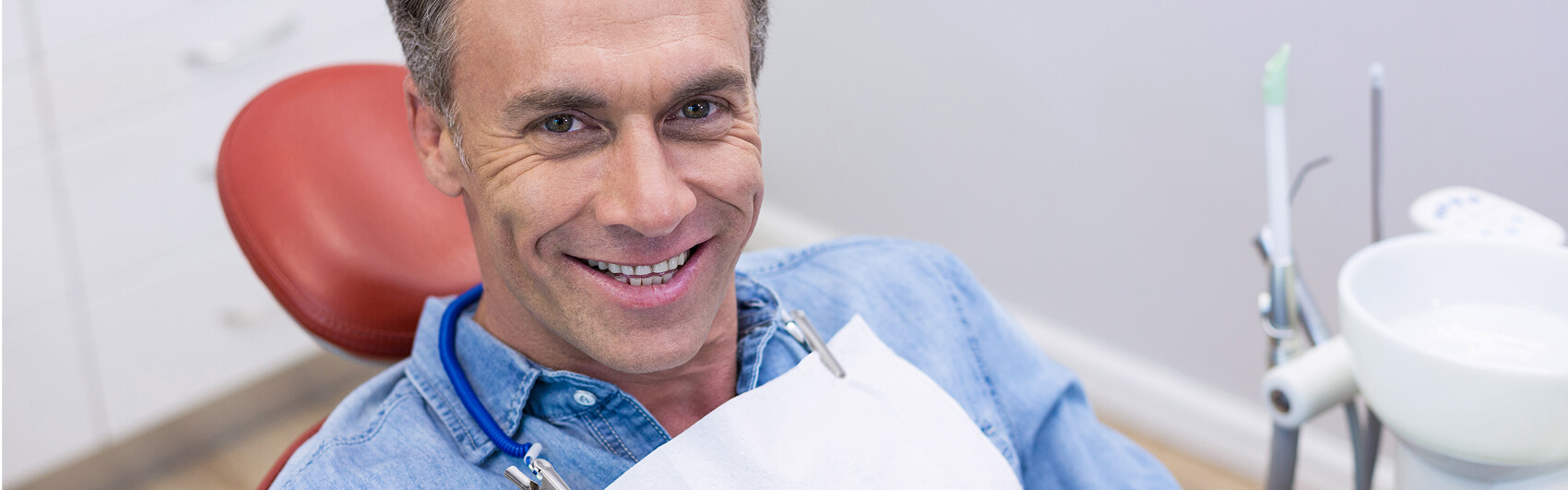 A dental staff member providing periodontal care or cleaning to a patient, illustrating gum disease treatment and oral hygiene services in Searcy AR
